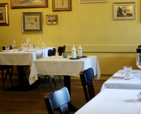 Restaurant interior: empty table & disinfectant